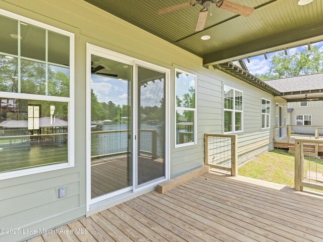 wooden deck featuring a water view and a ceiling fan