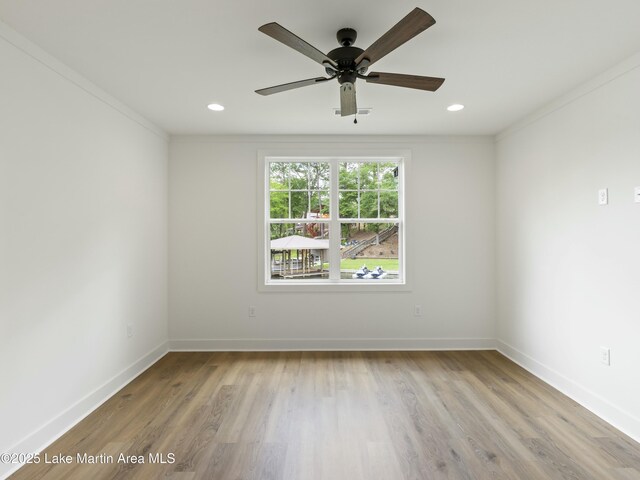 unfurnished room with recessed lighting, crown molding, baseboards, and wood finished floors