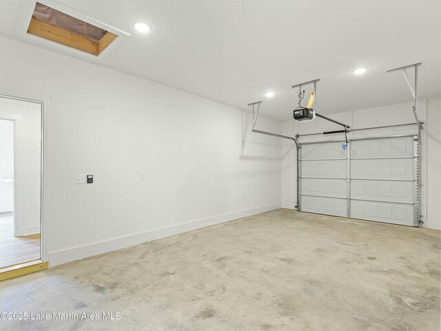 garage with a garage door opener and baseboards