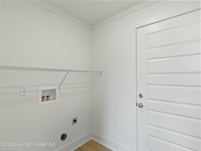 clothes washing area featuring laundry area, baseboards, wood finished floors, hookup for a washing machine, and hookup for an electric dryer