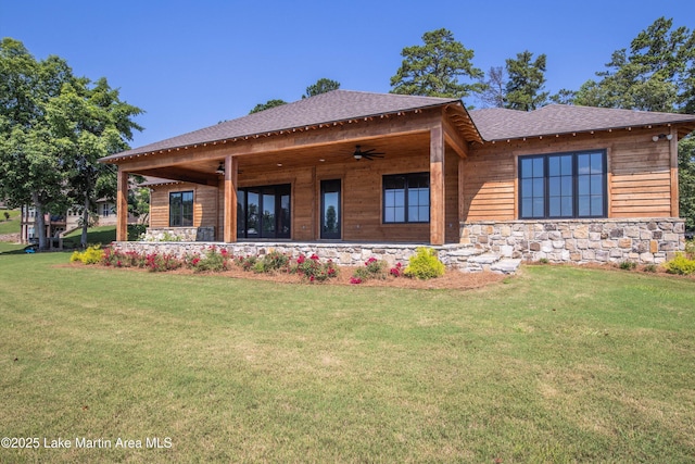 116 Water Oak Ln, Jacksons Gap, AL 36861 - back of property with ceiling fan, a lawn, stone siding, and a shingled roof