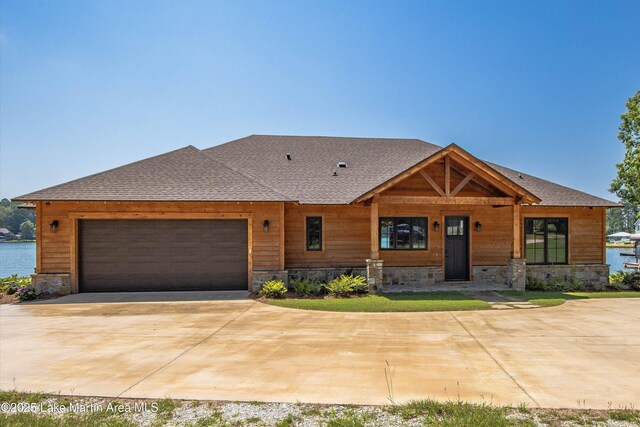 116 Water Oak Ln, Jacksons Gap, AL 36861 - view of front of home featuring stone siding, an attached garage, and driveway