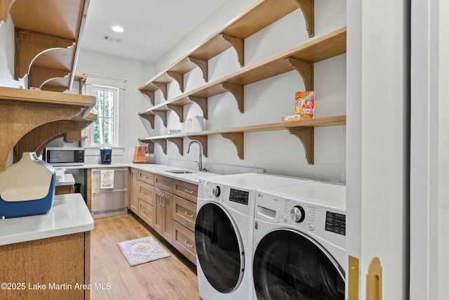 116 Water Oak Ln, Jacksons Gap, AL 36861 - laundry area with separate washer and dryer, light wood finished floors, cabinet space, and recessed lighting
