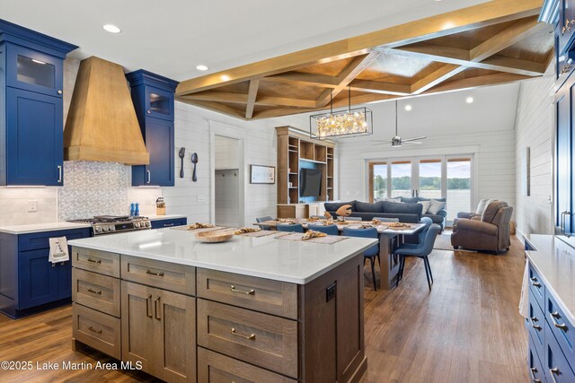 116 Water Oak Ln, Jacksons Gap, AL 36861 - kitchen with custom range hood, coffered ceiling, dark wood-style floors, light countertops, and a kitchen island