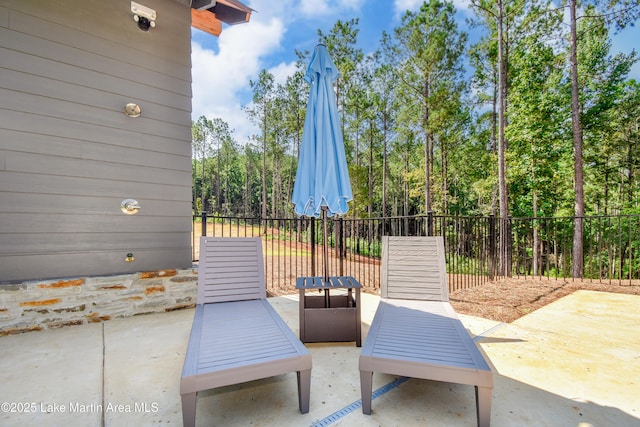 view of patio / terrace featuring fence