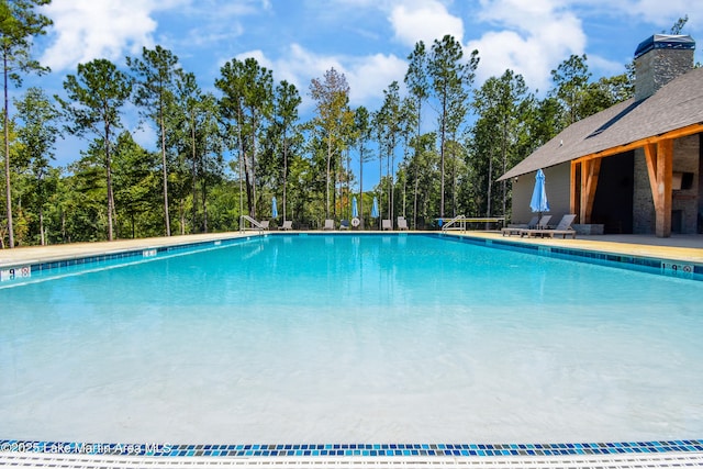 community pool with a patio area