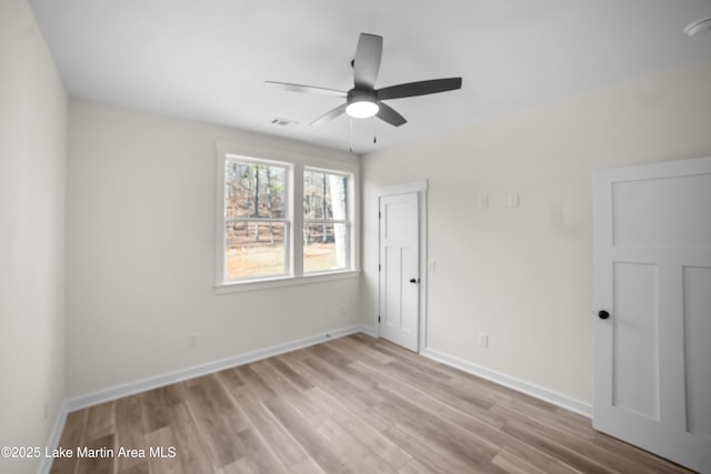 unfurnished bedroom with light wood finished floors, visible vents, and baseboards