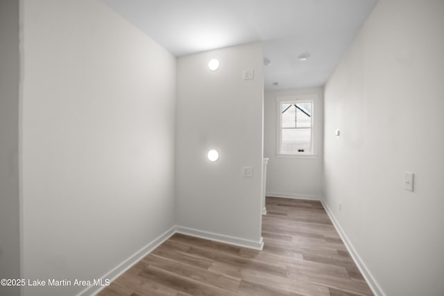 unfurnished room with wood finished floors and baseboards