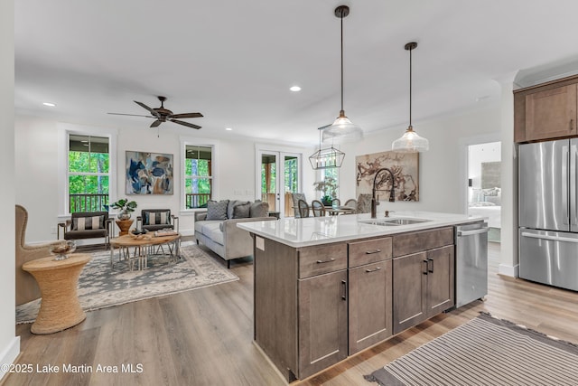 189 Magnolia Way, Dadeville, AL 36853 - kitchen with stainless steel appliances, a sink, light wood-type flooring, light countertops, and a ceiling fan