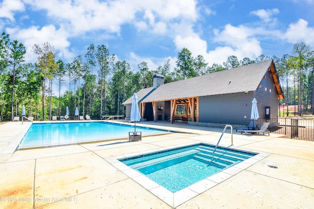 pool featuring a patio area and fence