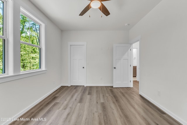 189 Magnolia Way, Dadeville, AL 36853 - unfurnished bedroom featuring multiple windows, light wood-style floors, and baseboards