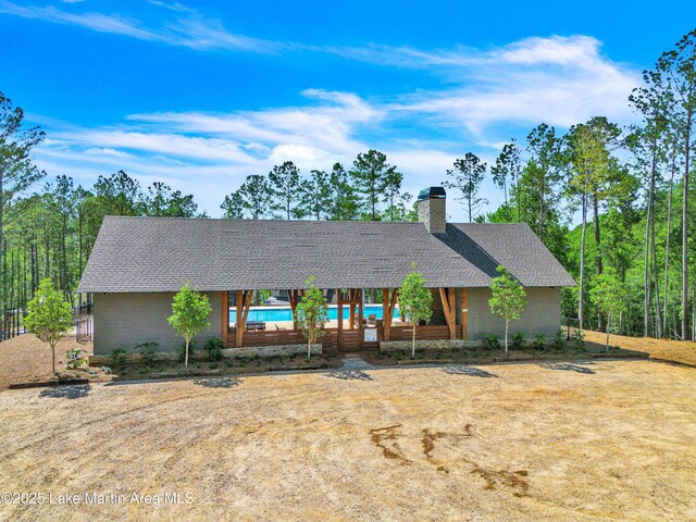 189 Magnolia Way, Dadeville, AL 36853 - view of front of home with roof with shingles, an outdoor pool, and a chimney