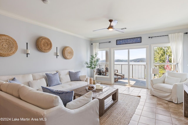 living room with ceiling fan, light tile patterned floors, ornamental molding, and a water view