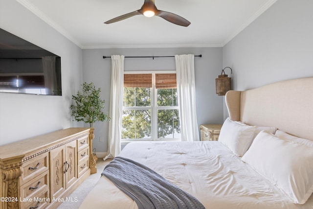 carpeted bedroom featuring ceiling fan and crown molding