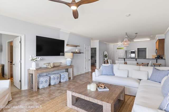 living room with ceiling fan and ornamental molding