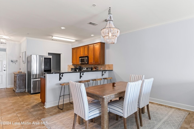 dining space featuring an inviting chandelier and crown molding