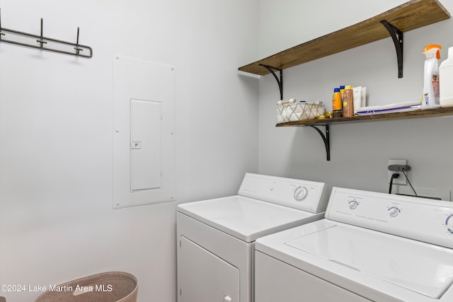 washroom with electric panel and washer and clothes dryer