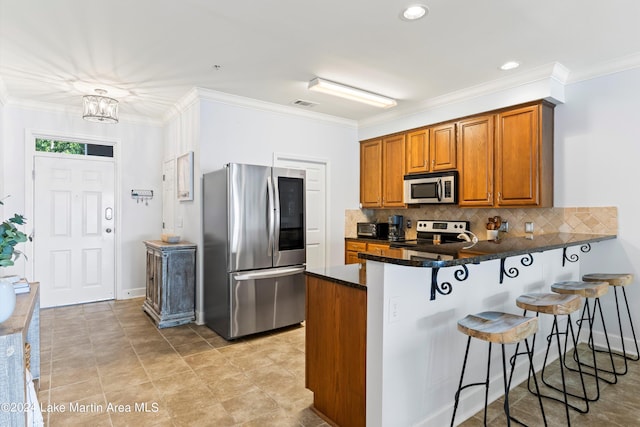 kitchen with pendant lighting, kitchen peninsula, decorative backsplash, appliances with stainless steel finishes, and a chandelier