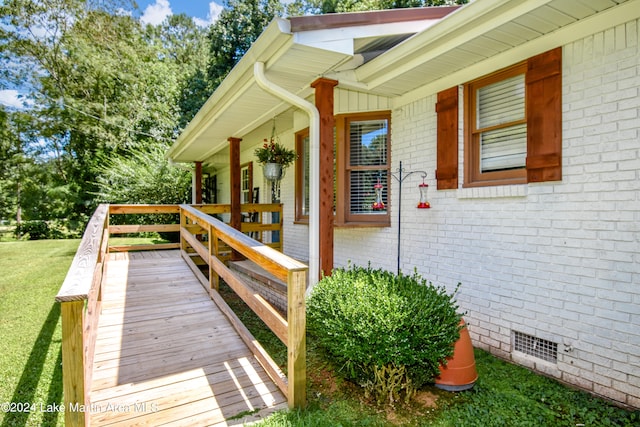 property entrance featuring a yard and covered porch