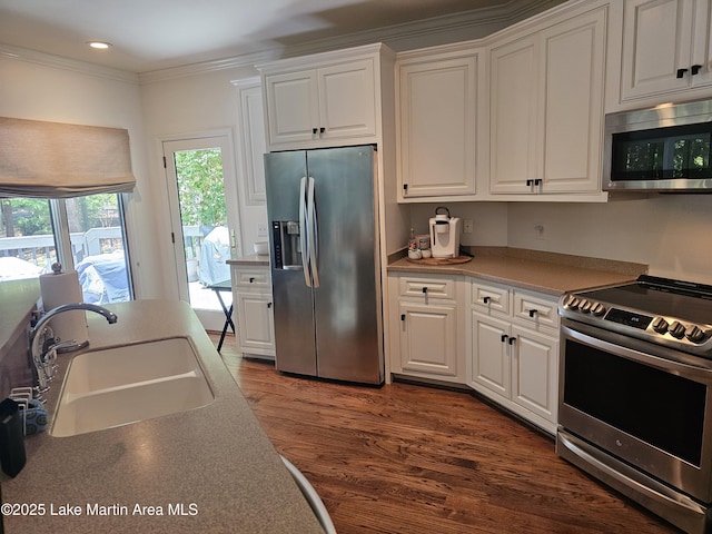 67 Lakeview Dr Unit 10H, Alexander City, AL 35010 - kitchen with stainless steel appliances, white cabinetry, dark wood finished floors, ornamental molding, and recessed lighting