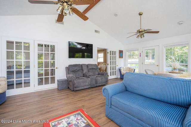 living room with high vaulted ceiling and wood-type flooring