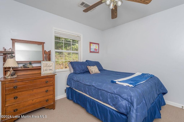 bedroom with ceiling fan and light colored carpet