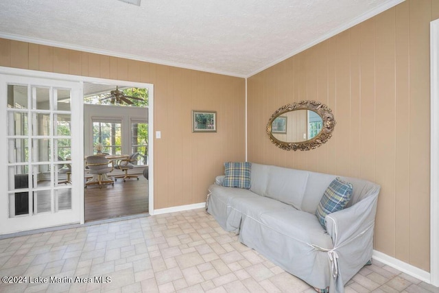 living room featuring crown molding and wood walls