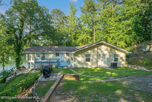 single story home featuring central AC, a front lawn, and a deck