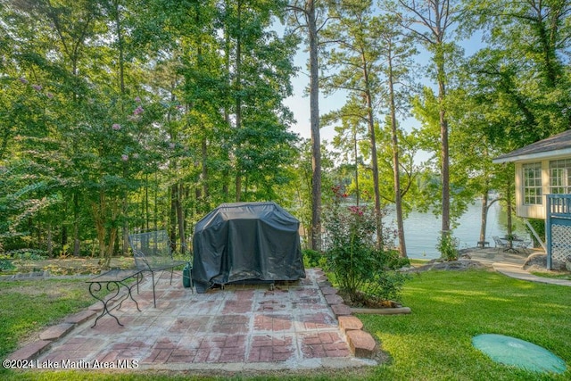 view of patio / terrace featuring a grill and a water view