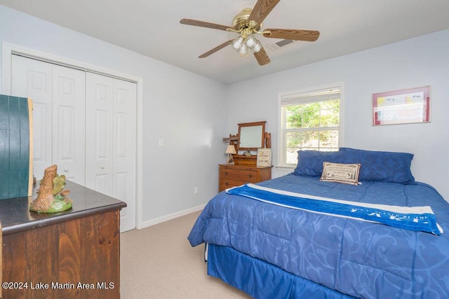 carpeted bedroom featuring a closet and ceiling fan