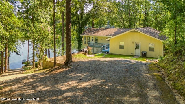 back of house featuring a water view and central AC