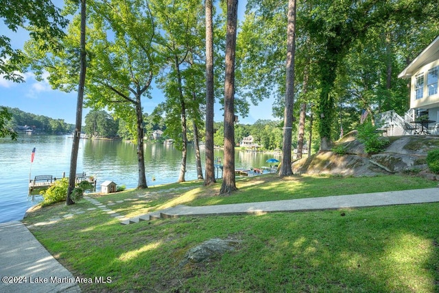 exterior space featuring a lawn and a water view