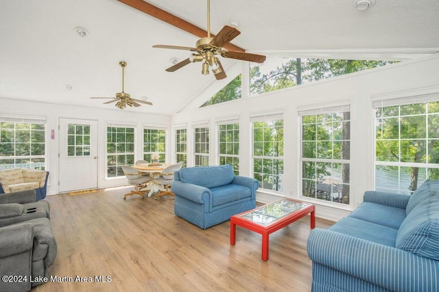 sunroom / solarium featuring lofted ceiling with beams