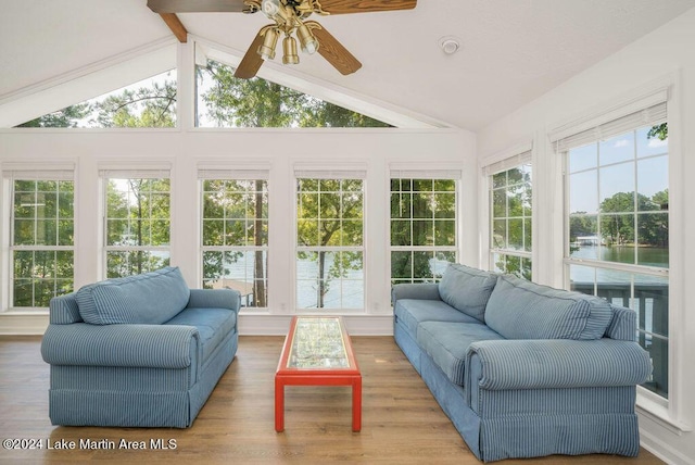 sunroom / solarium with vaulted ceiling with beams, ceiling fan, and a water view