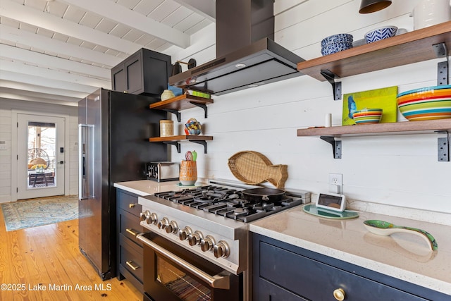 kitchen with high quality appliances, light wood finished floors, island exhaust hood, and open shelves