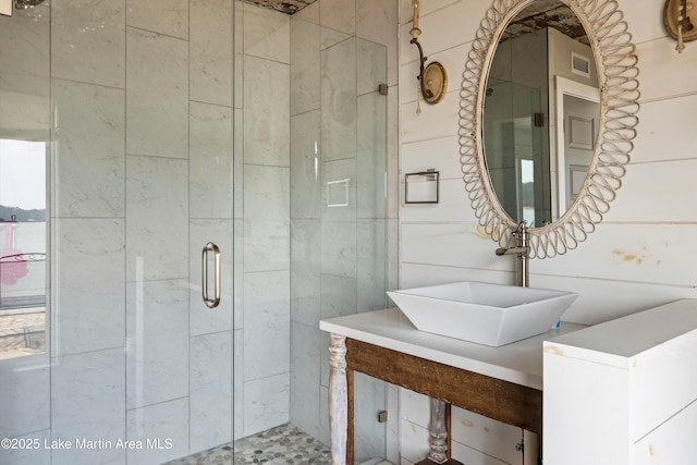 full bath with visible vents, a sink, and a shower stall