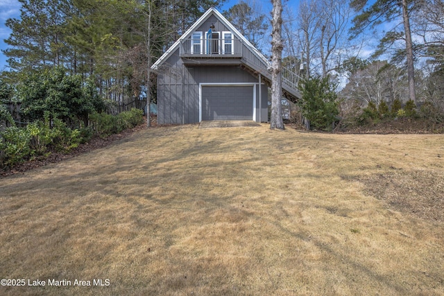 view of home's exterior with a yard, stairway, and an attached garage