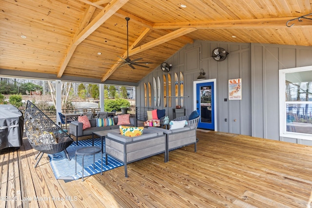 wooden deck with area for grilling, an outdoor living space, and a ceiling fan