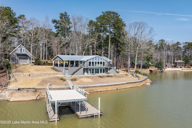 dock area with stairway and a deck with water view