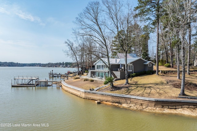 dock area with stairway, a water view, and boat lift