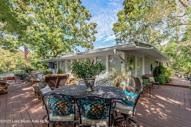 wooden deck featuring outdoor dining area