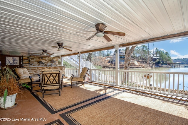 view of patio featuring an outdoor living space, a water view, ceiling fan, and stairway