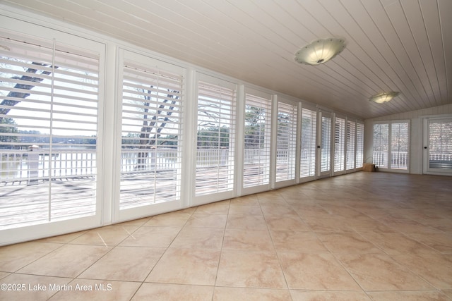 unfurnished sunroom with vaulted ceiling and wooden ceiling