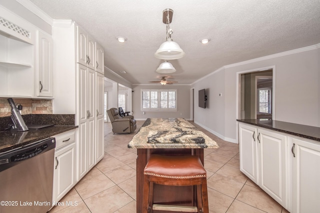 kitchen featuring white cabinets, dishwasher, a kitchen island, hanging light fixtures, and crown molding