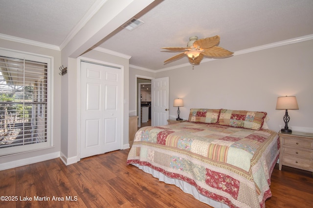 bedroom with baseboards, visible vents, wood finished floors, and ornamental molding