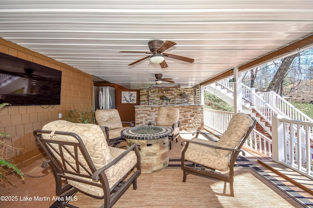 view of patio / terrace with ceiling fan and stairs