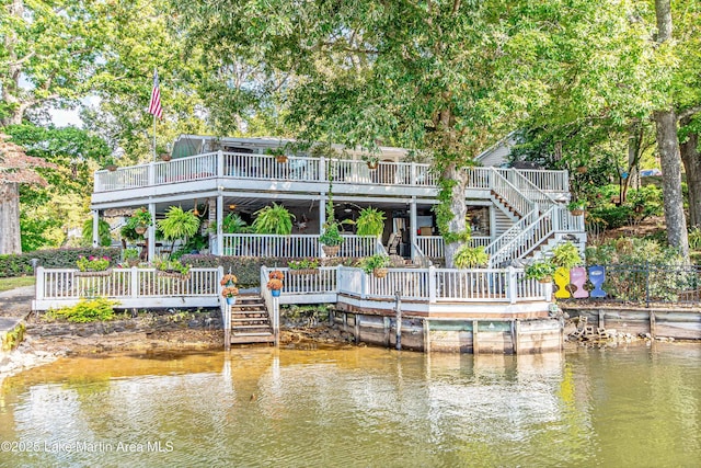 view of dock featuring stairway and a deck with water view