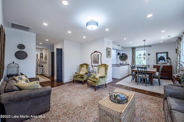 living room featuring visible vents, recessed lighting, baseboards, and wood finished floors