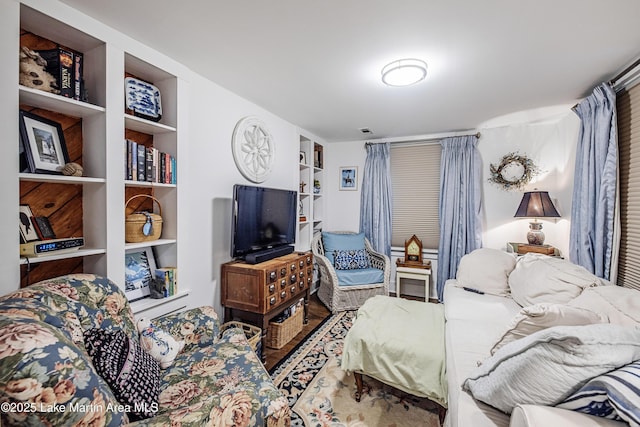 living area with visible vents and built in shelves