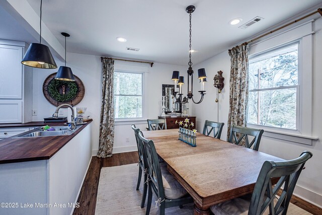 dining area with dark wood-style floors, visible vents, recessed lighting, and baseboards